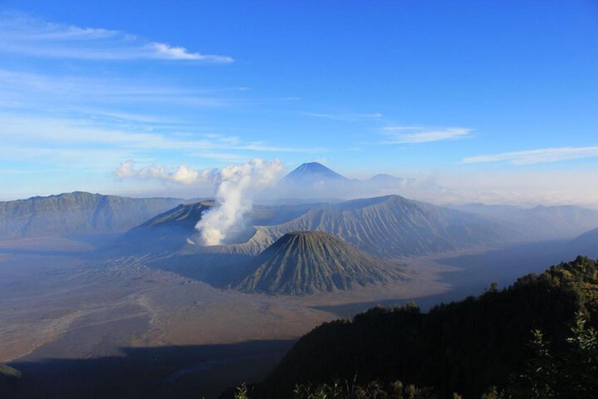a view of a mountain with smoke coming out of it