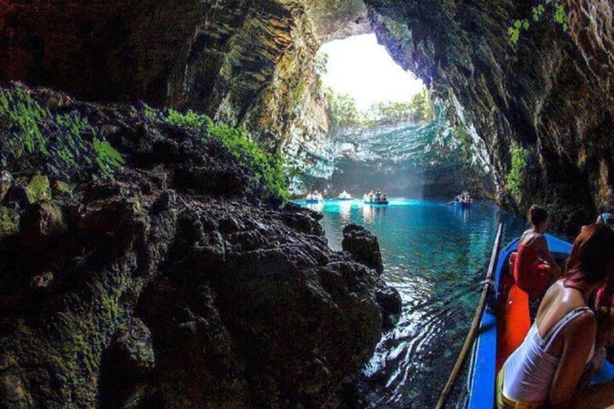 a group of people in a boat in a cave