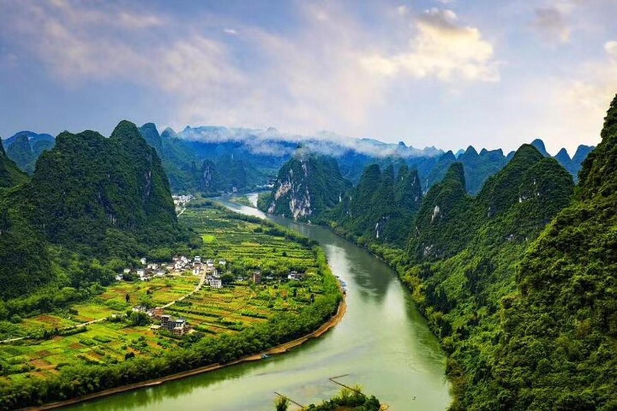 an aerial view of a river with mountains in the background