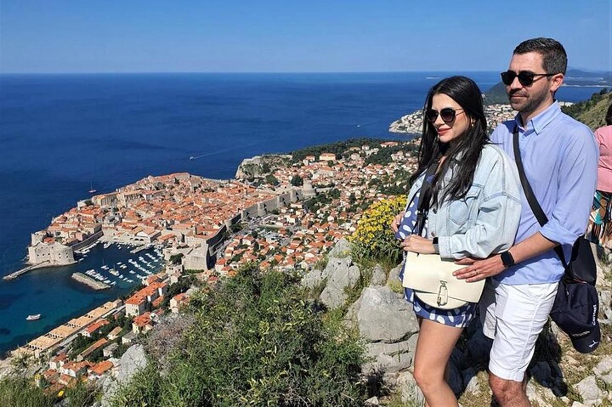 a man and a woman standing on top of a mountain