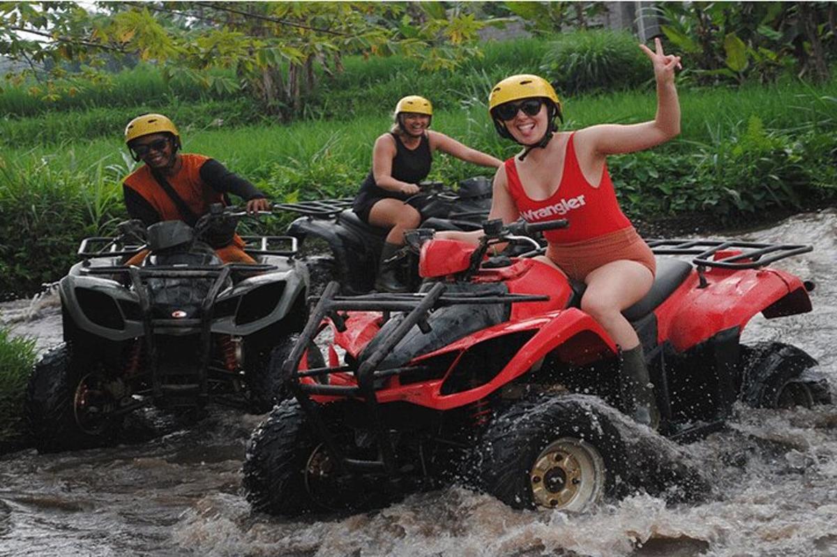 a group of people riding atvs in the water