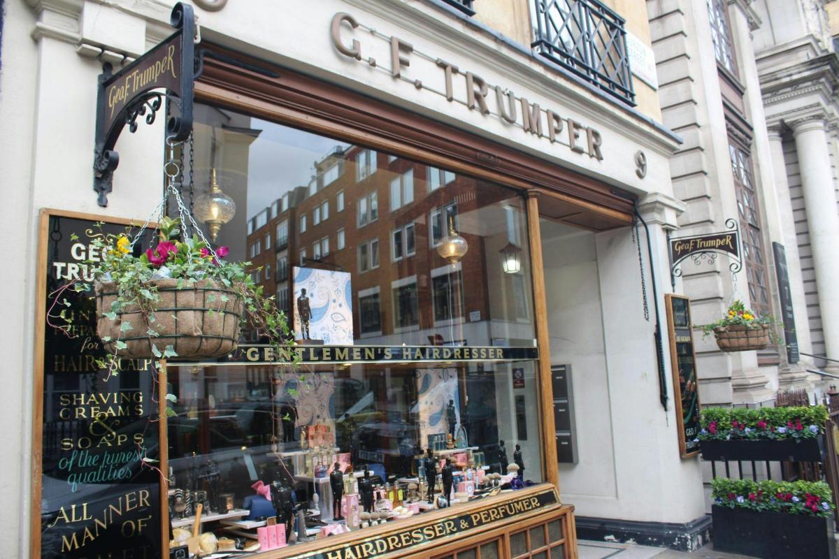 a store front of a store with a flower basket in the window