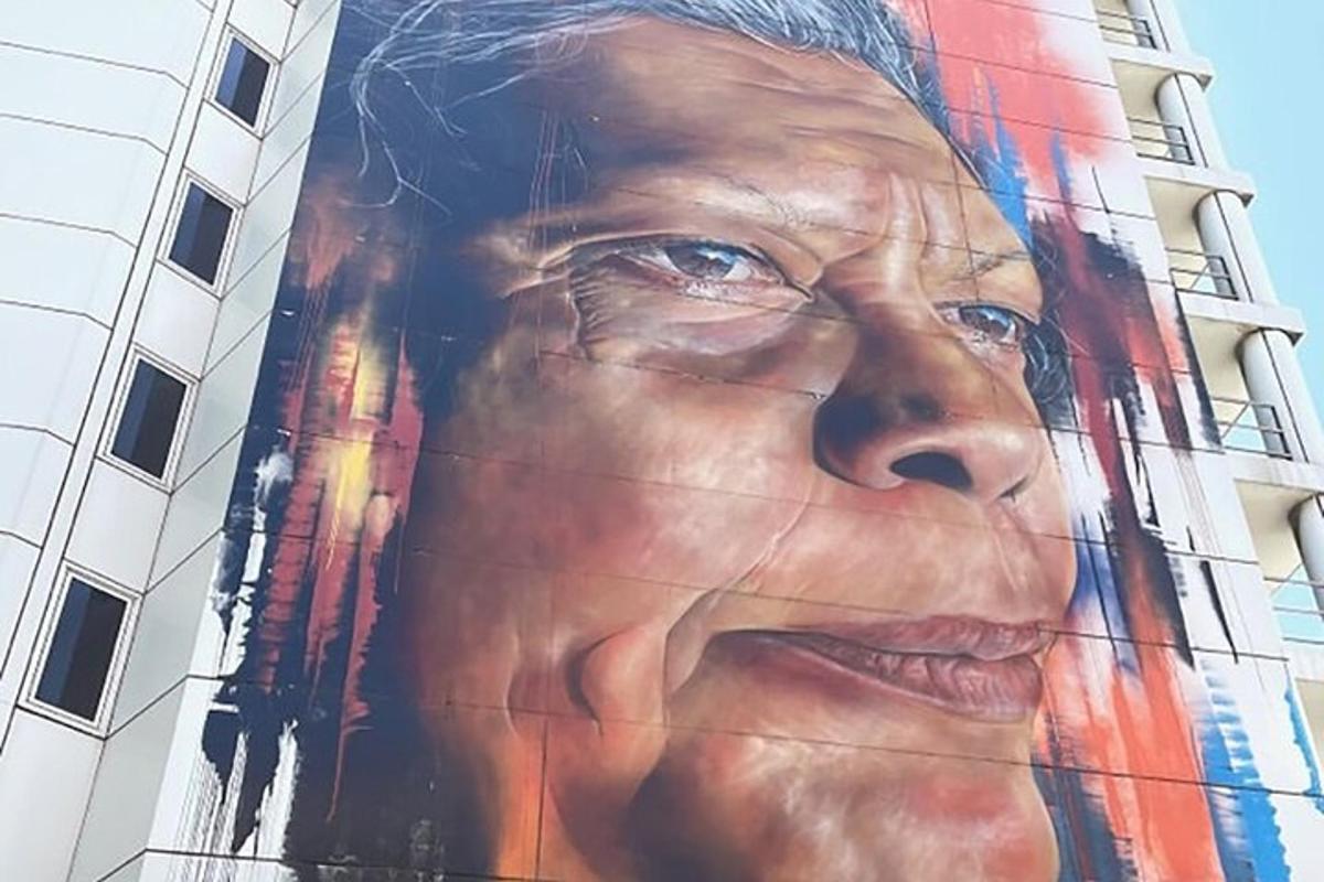 mural besar seorang wanita di sisi bangunan