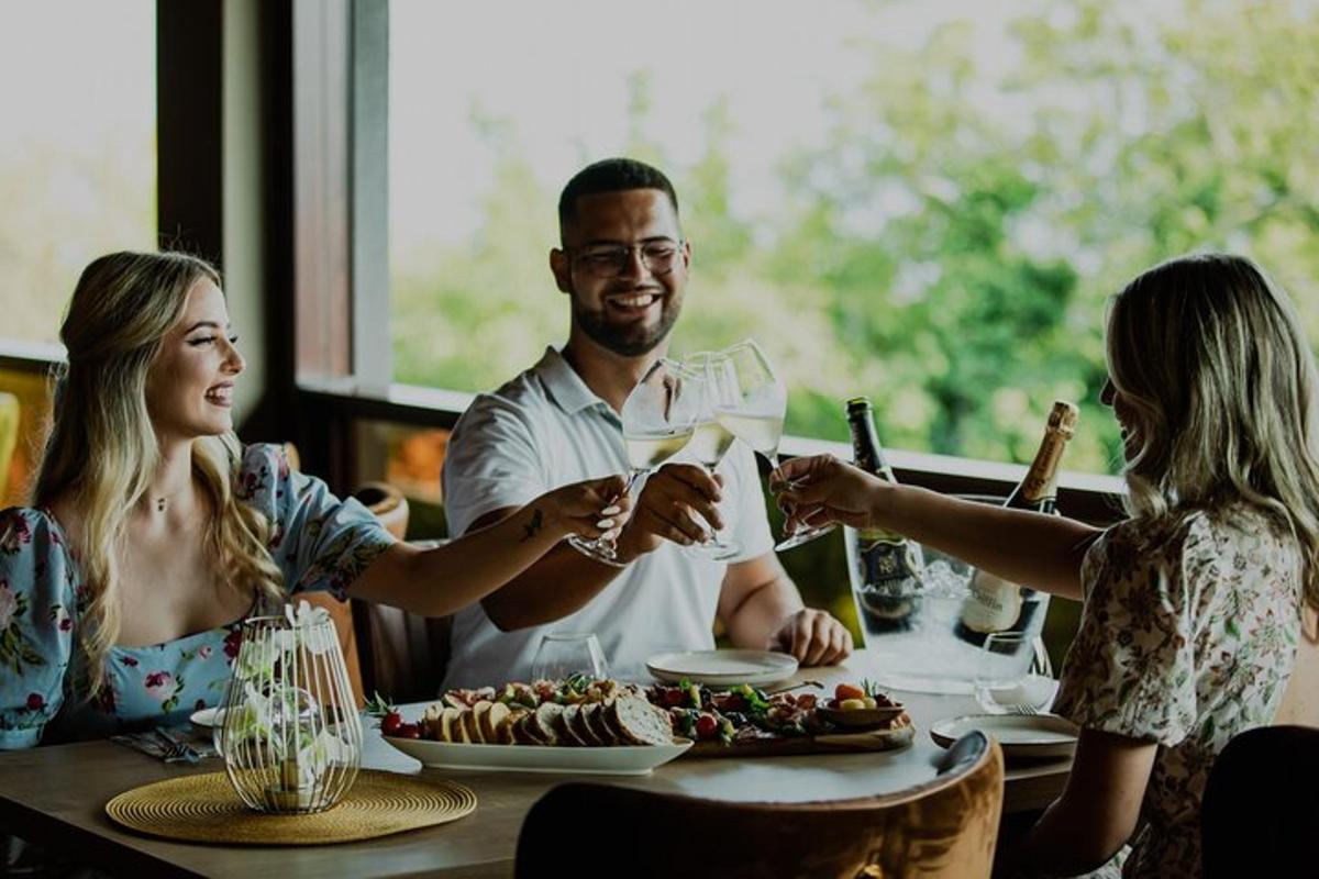 a group of people sitting around a table with wine glasses