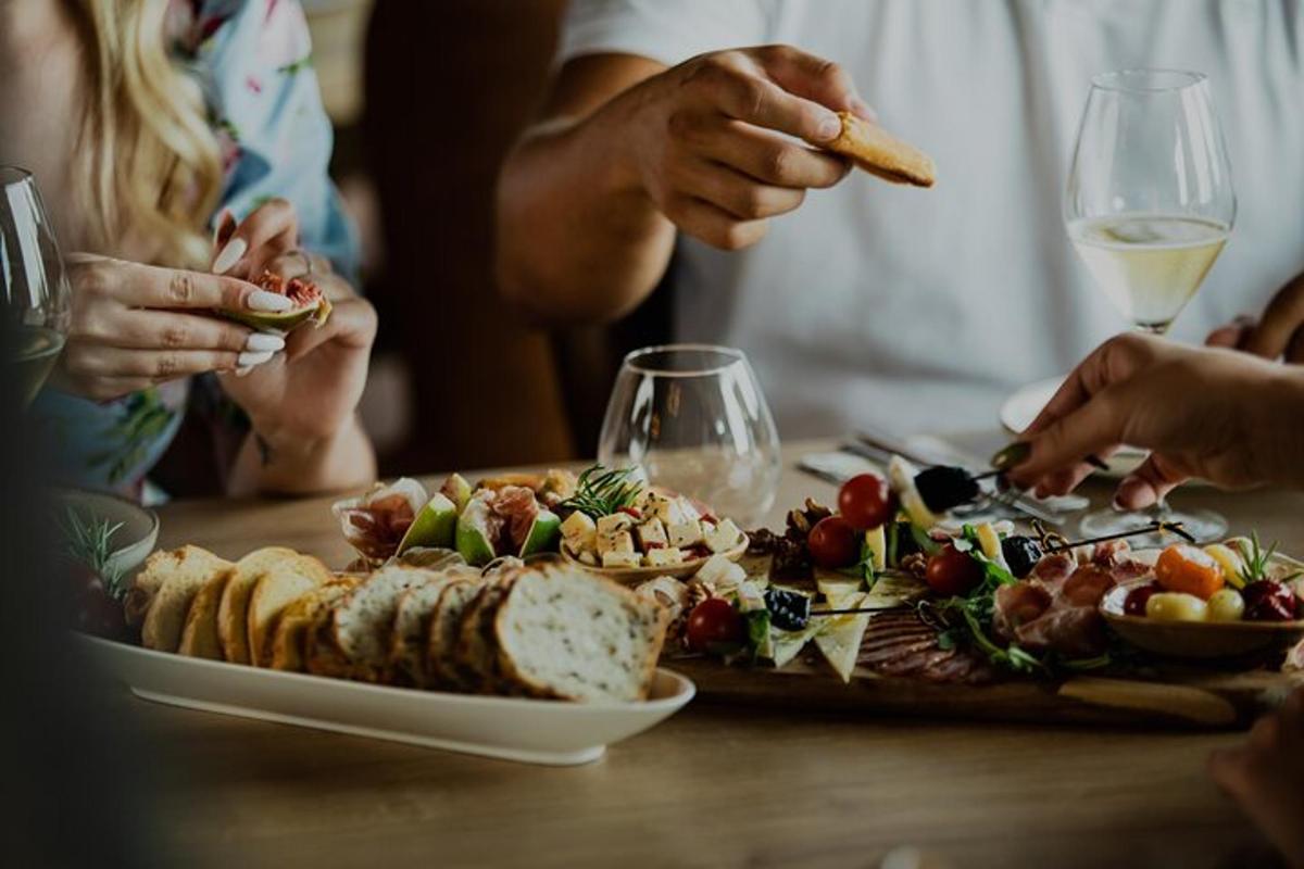 a group of people sitting at a table with a plate of food