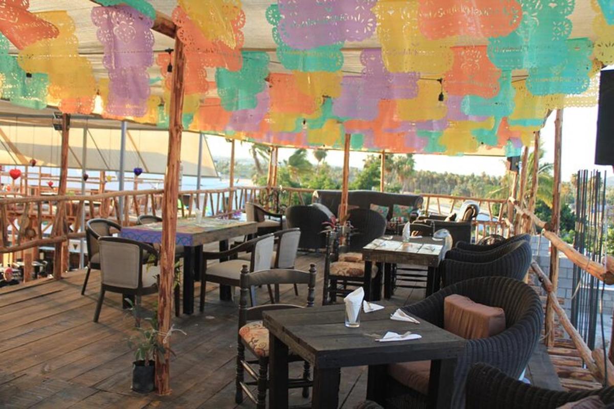 a restaurant with tables and chairs on a deck