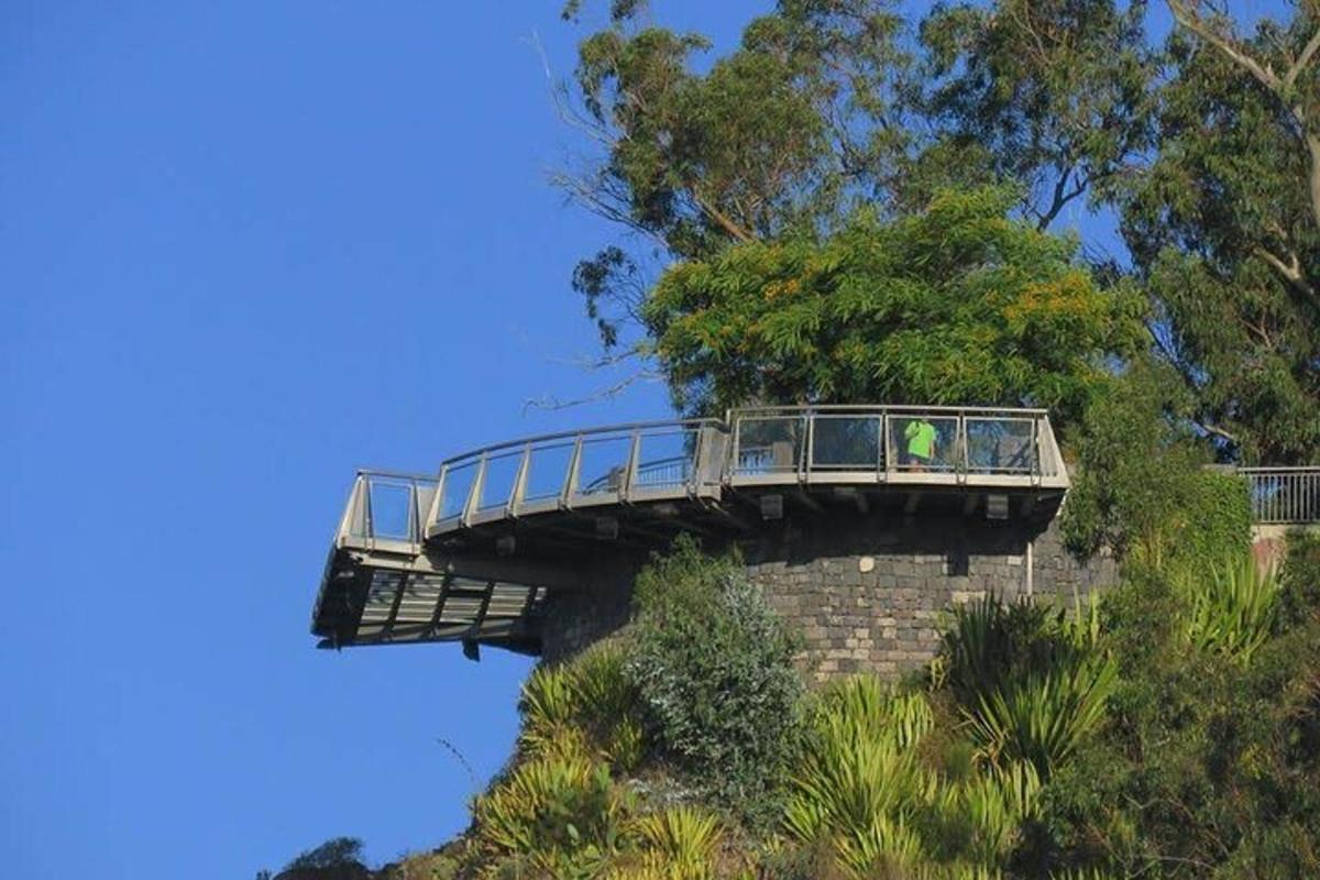 a bridge on top of a hill with people on it