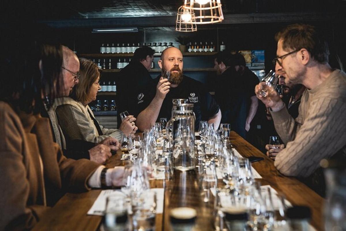 een groep mensen die aan een tafel zitten en wijn drinken