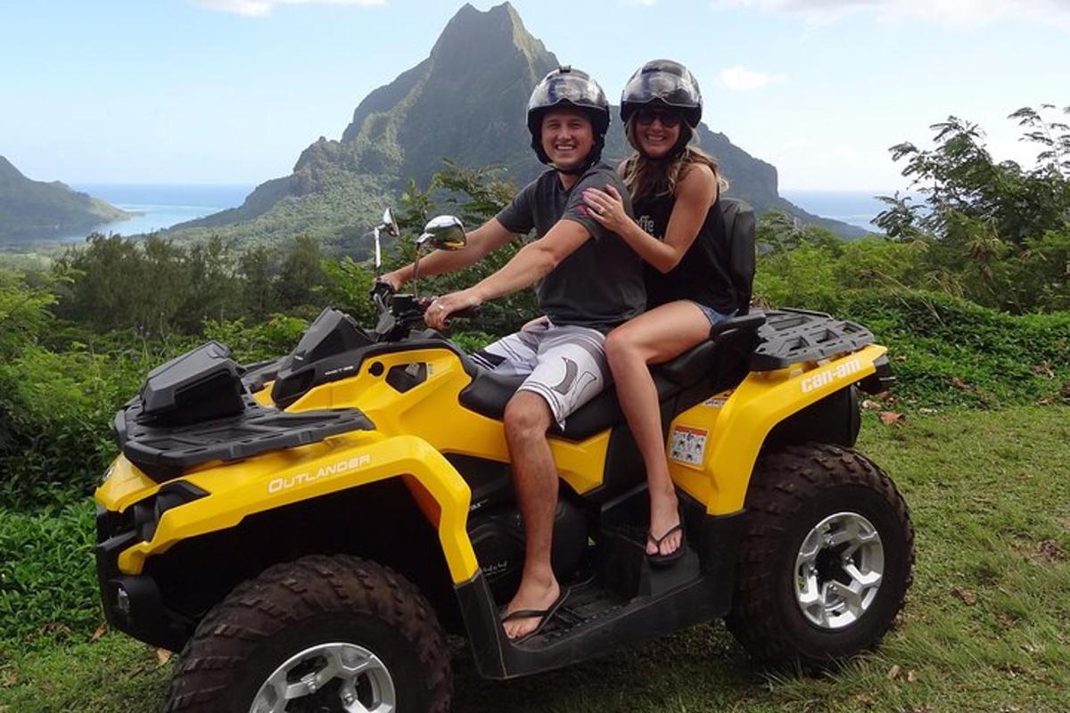 a man and a woman sitting on a atv