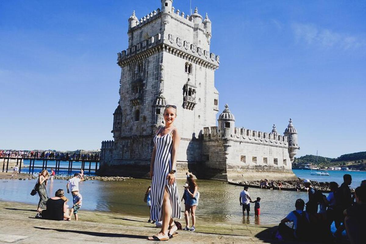 una donna con un abito a righe in piedi davanti a una torre