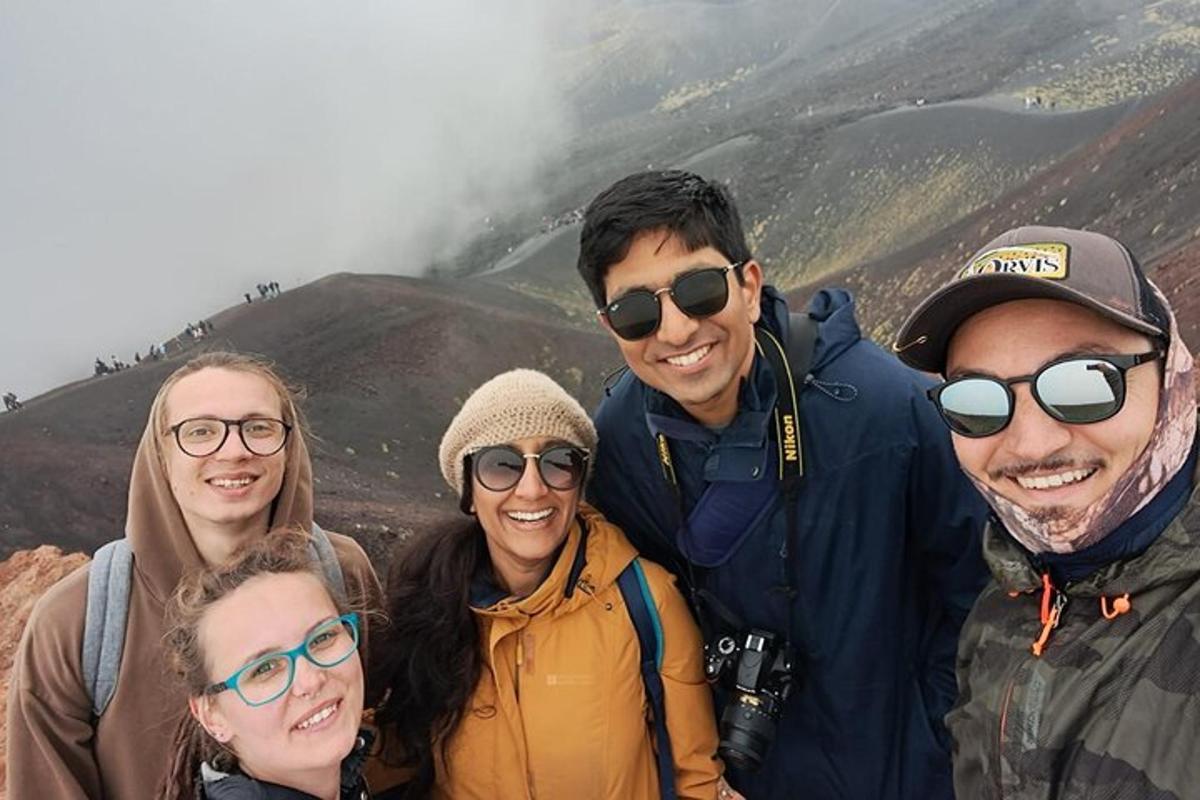 a group of people standing on top of a mountain