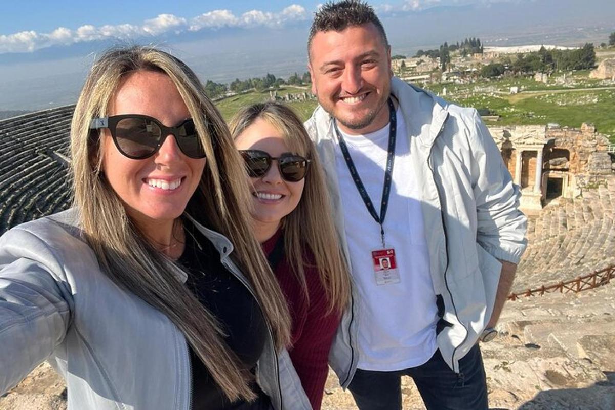 three people posing for a picture at the coliseum