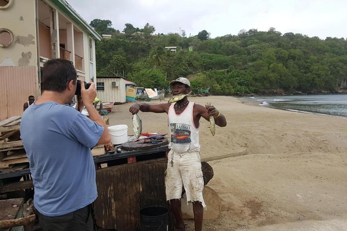 a man taking a picture of a man standing on the beach