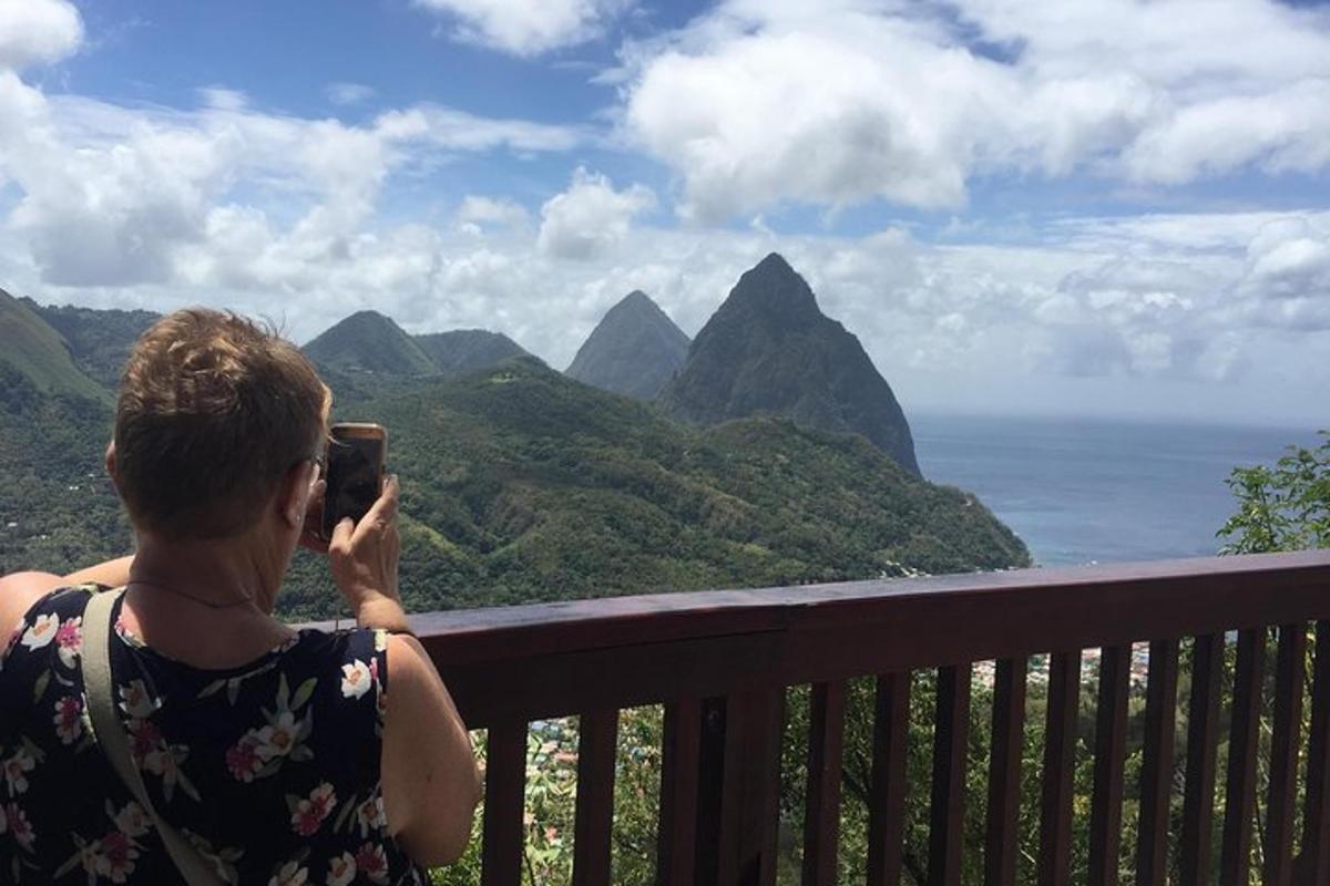 a woman taking a picture of the mountains