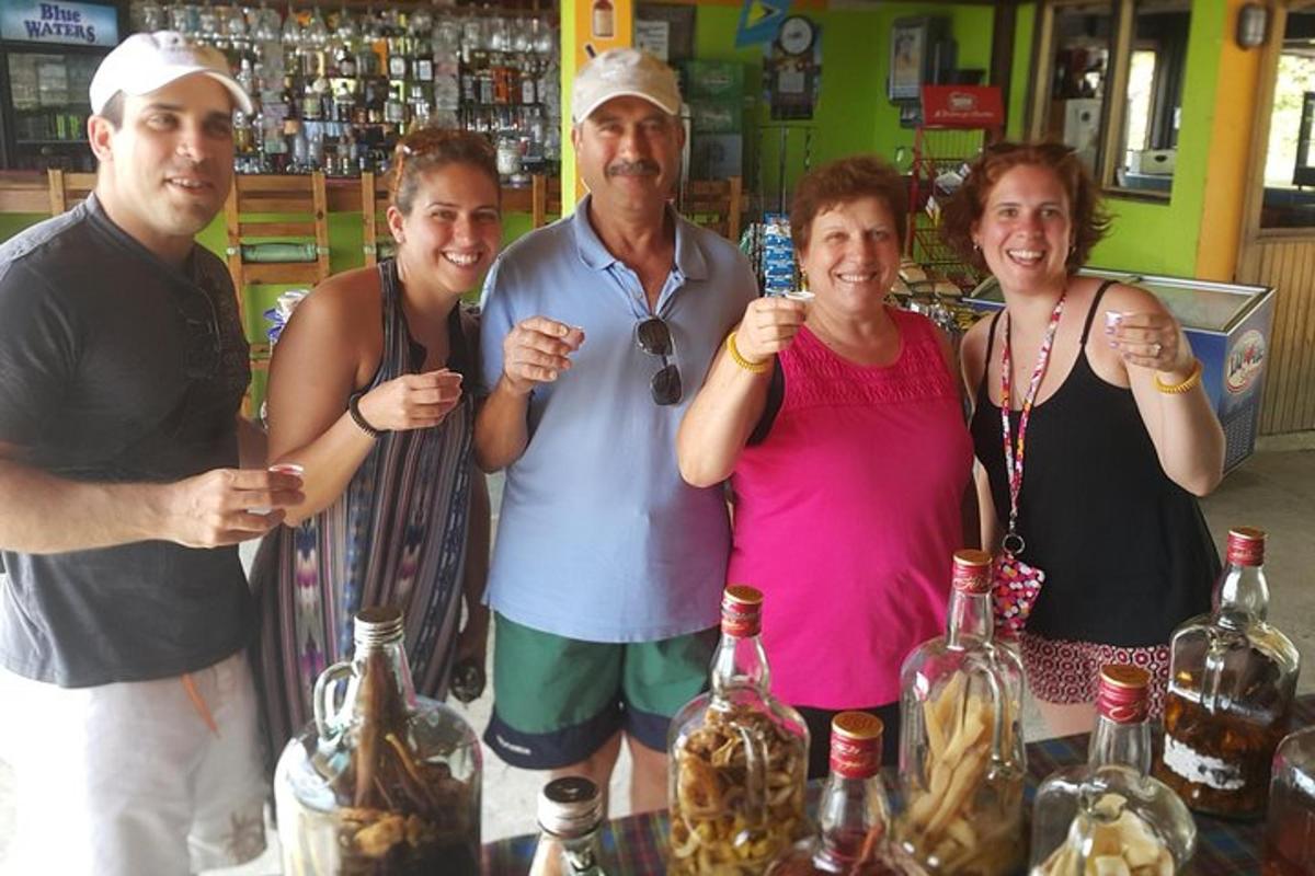 a group of people standing next to a bar with bottles of wine