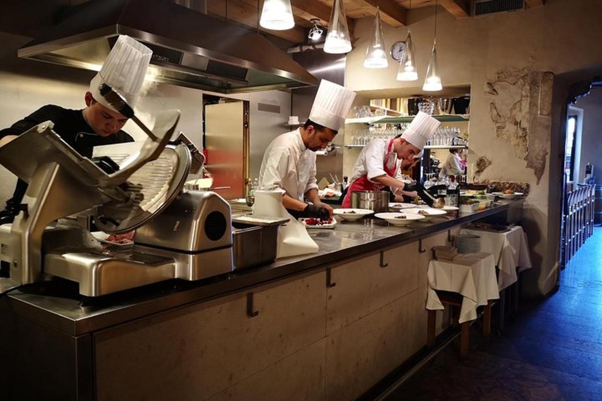 a group of chefs preparing food in a kitchen