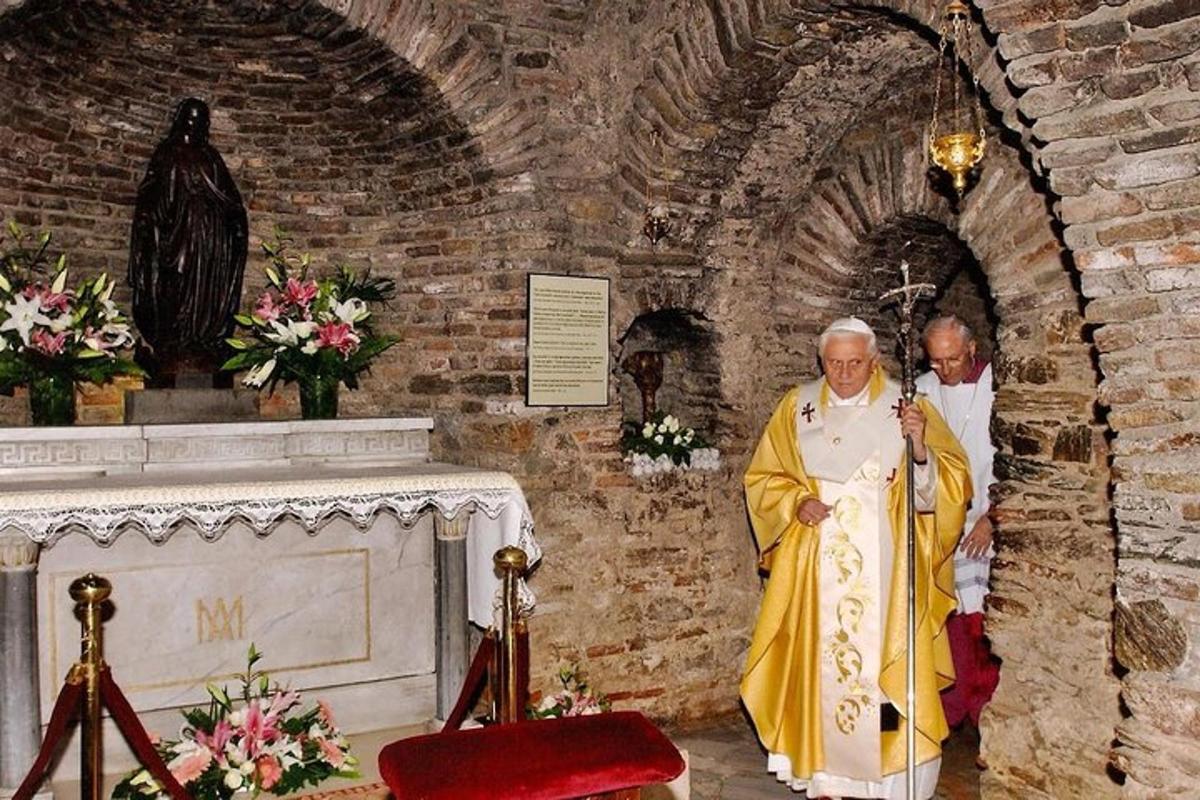 two priests standing in a church with a grave