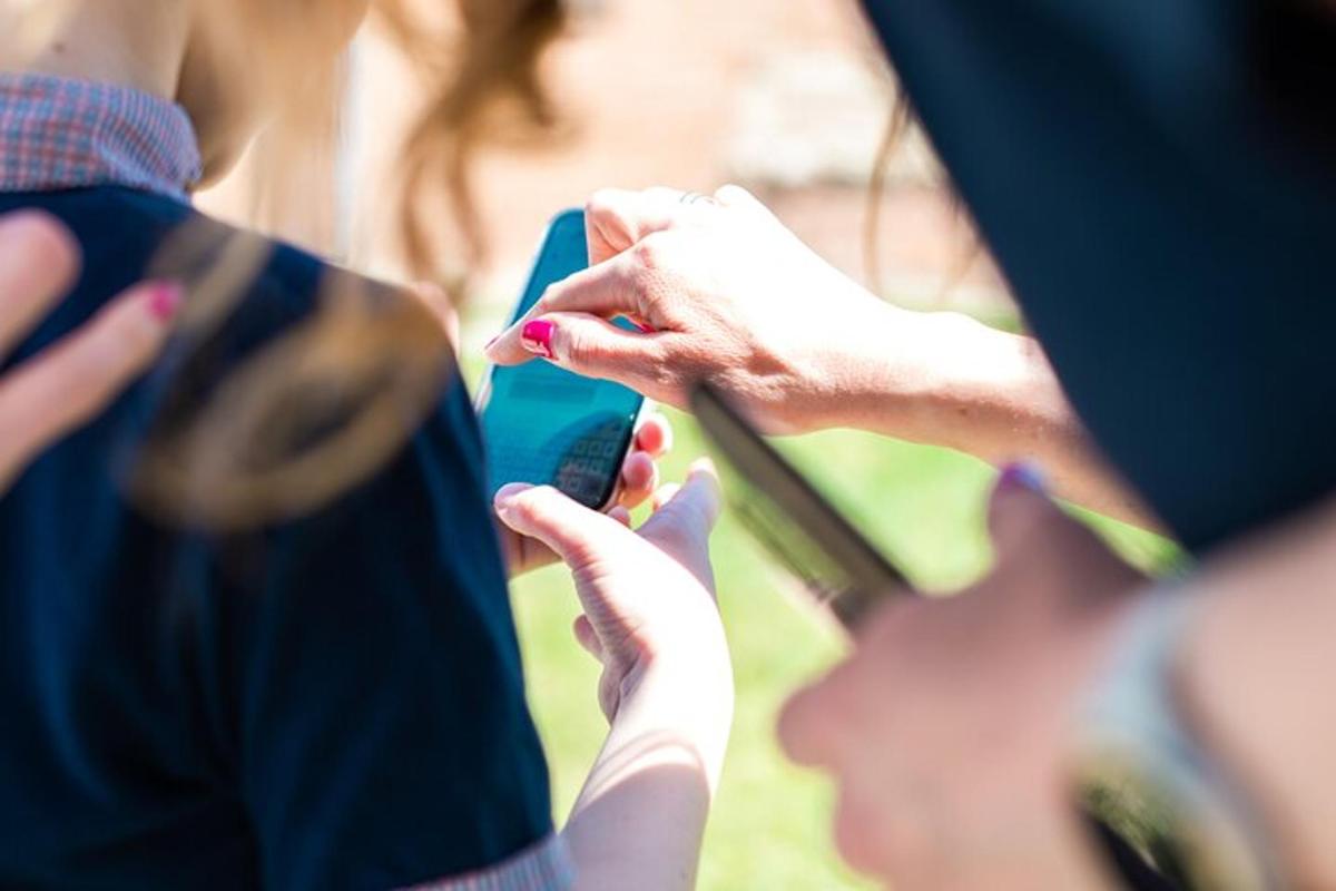 a person holding a cell phone in their hands