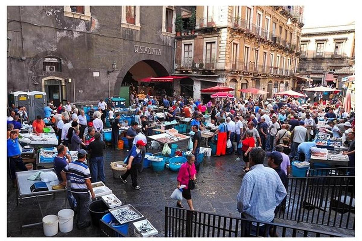 a crowd of people standing in a street market