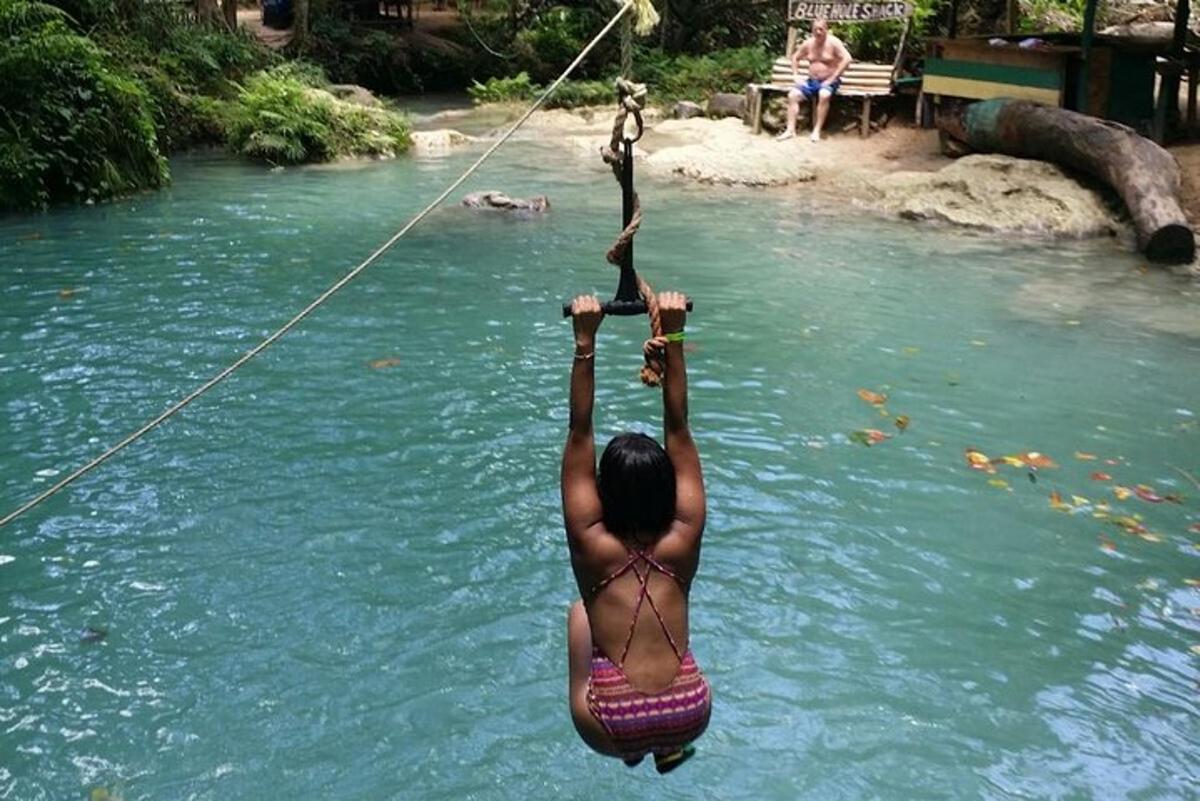 a woman in the water on a rope in a river