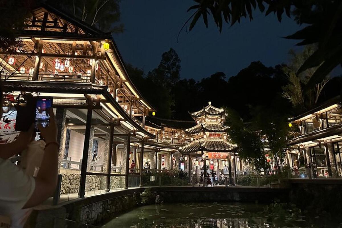 a building with a pond in front of it at night