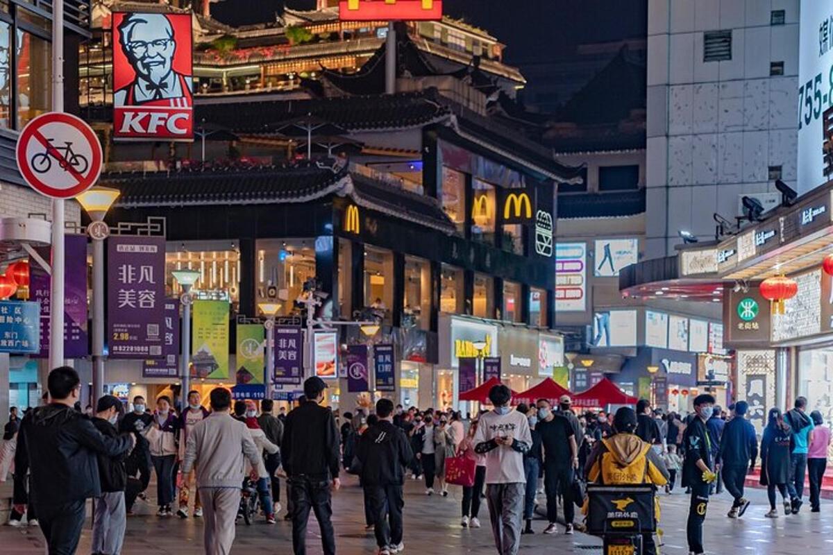 a crowd of people walking down a busy city street