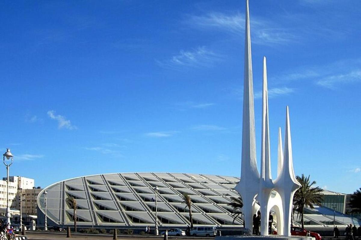 a large stadium with a large building in front of it