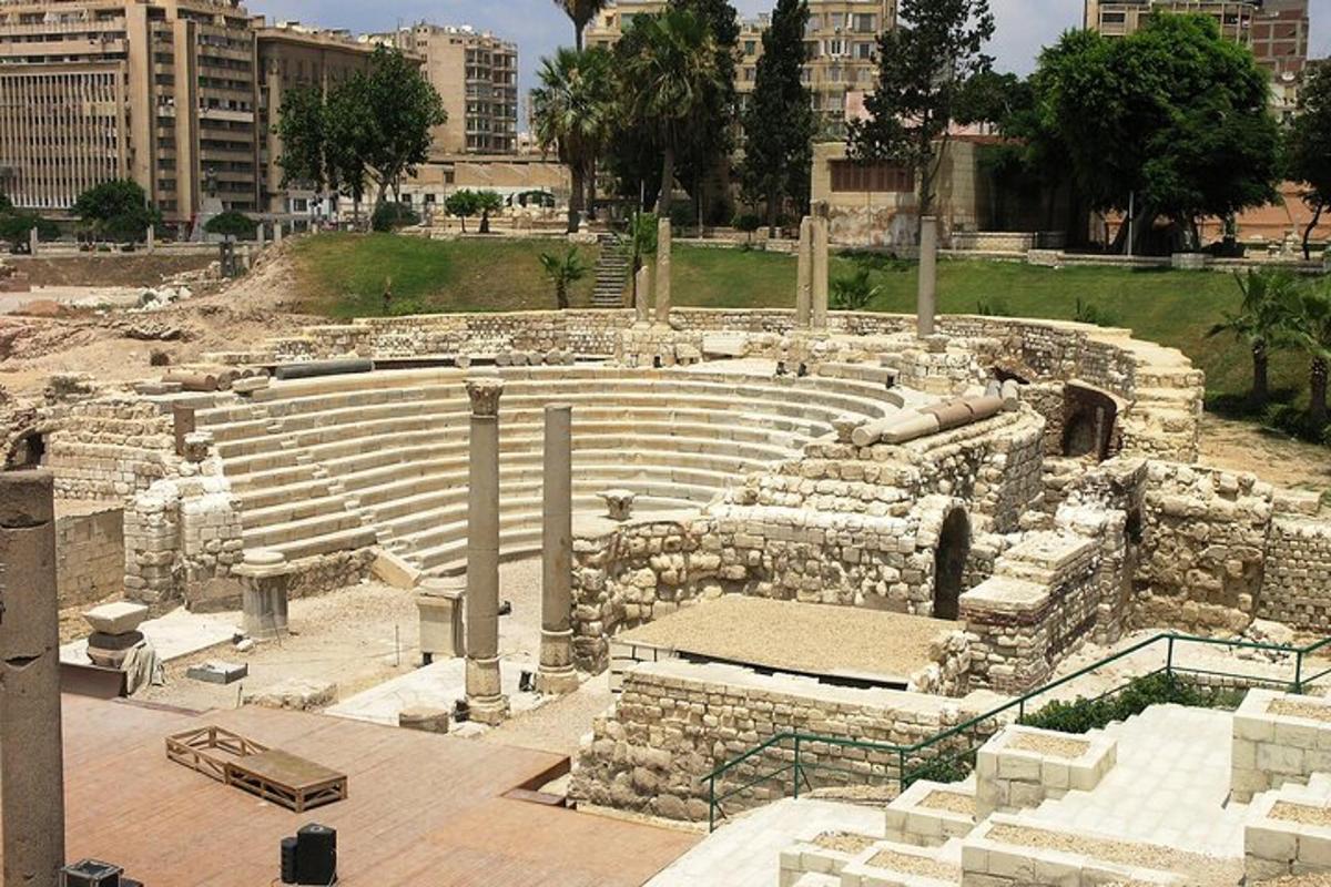 a large amphitheater in a city with buildings