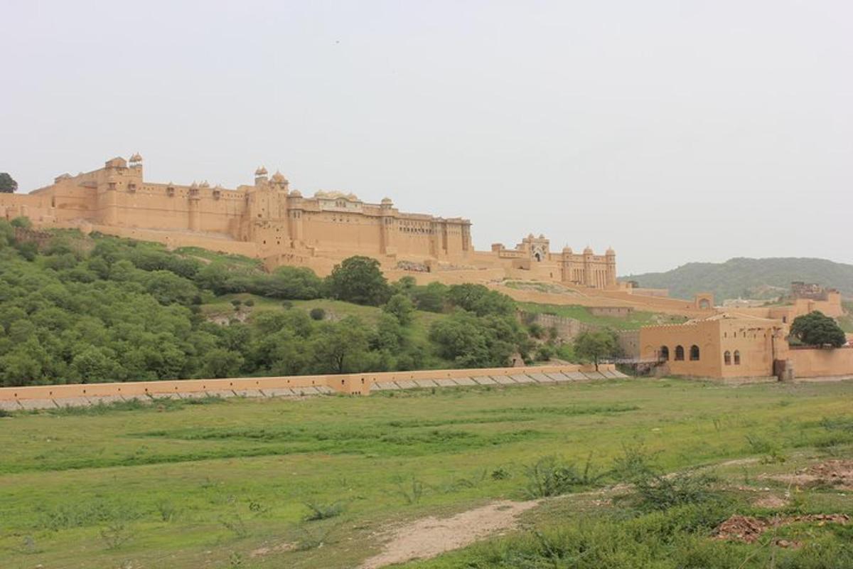 a large building on top of a hill with a field
