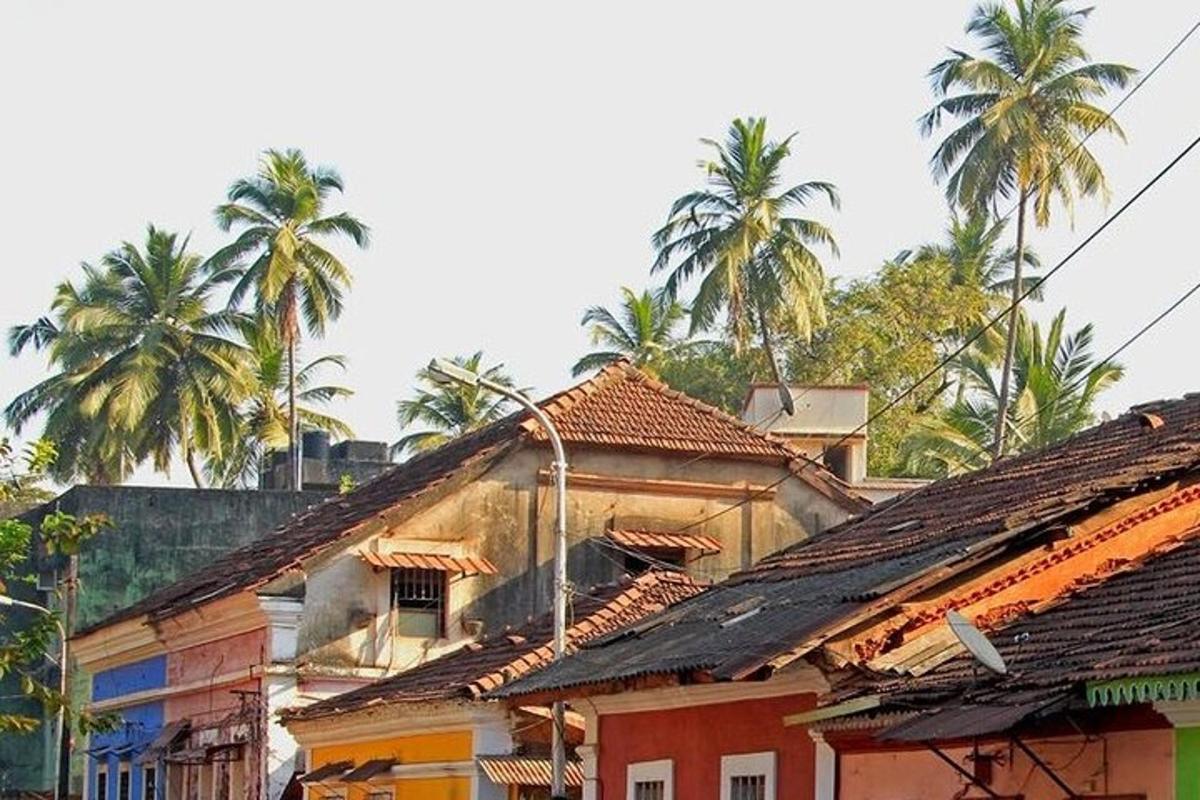 a group of buildings with palm trees in the background