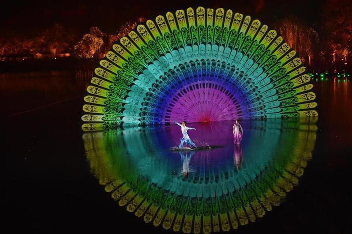 a woman is standing in front of a large colorful display