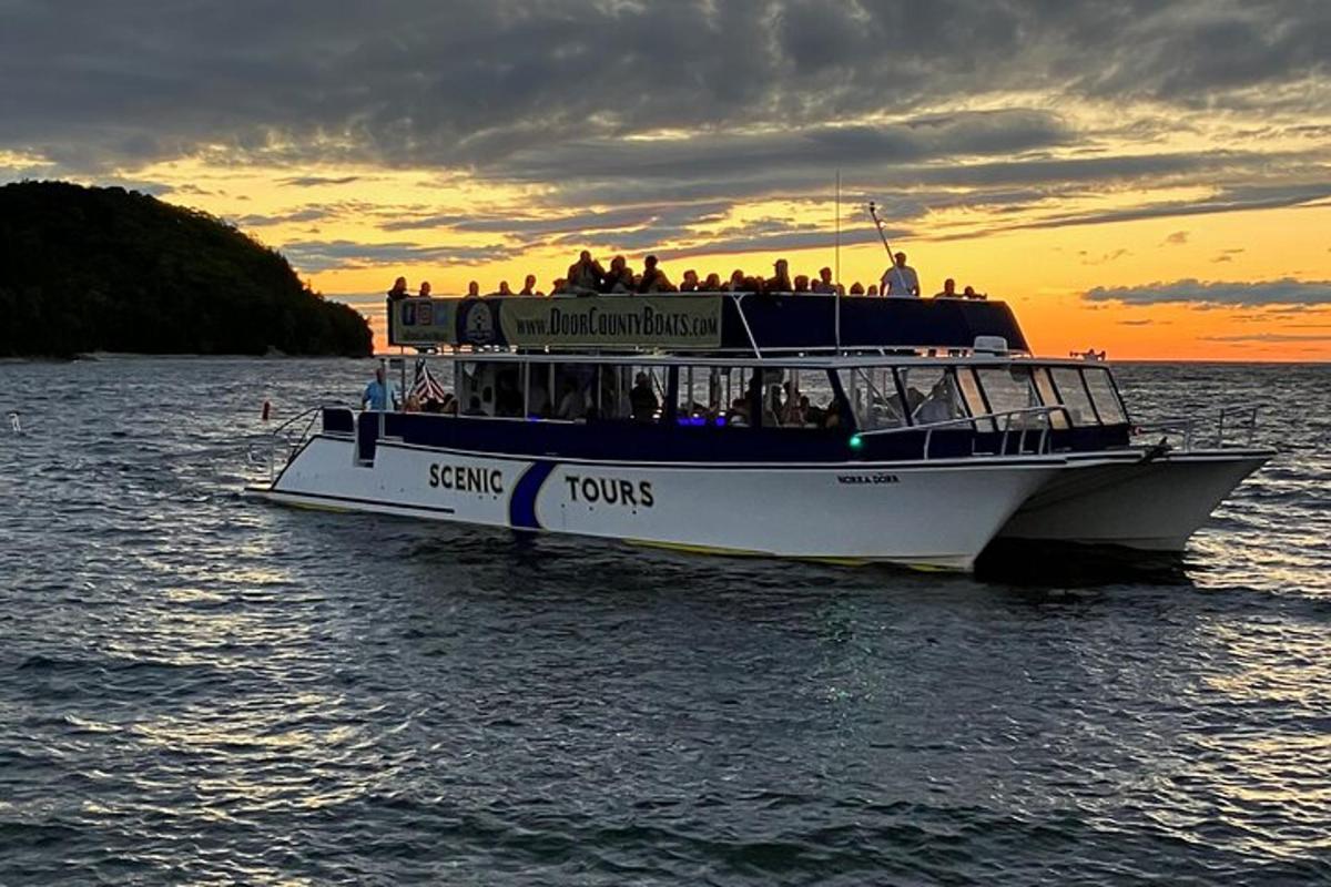 a ferry boat in the water at sunset