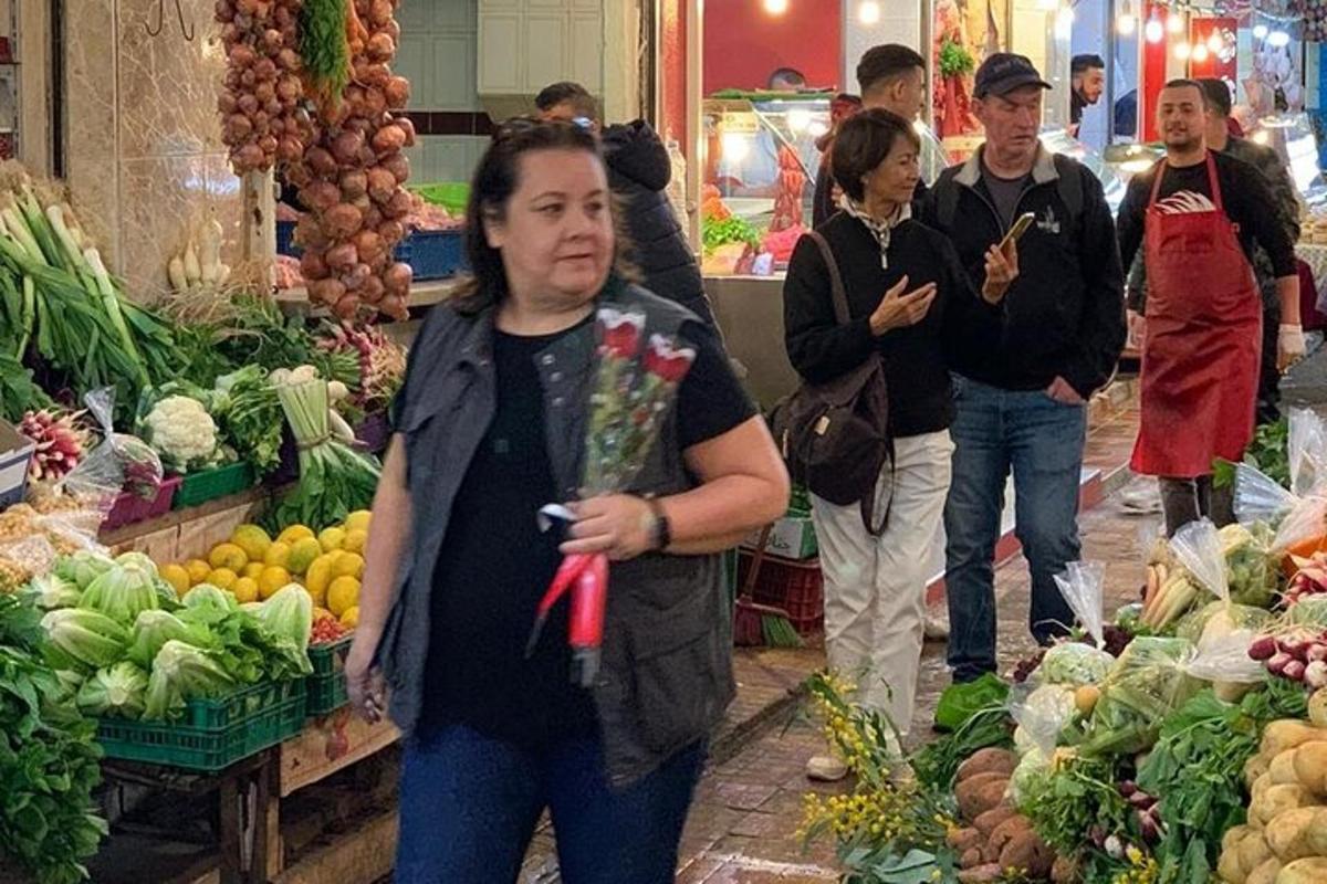 un bărbat care ține un buchet de flori într-o piață