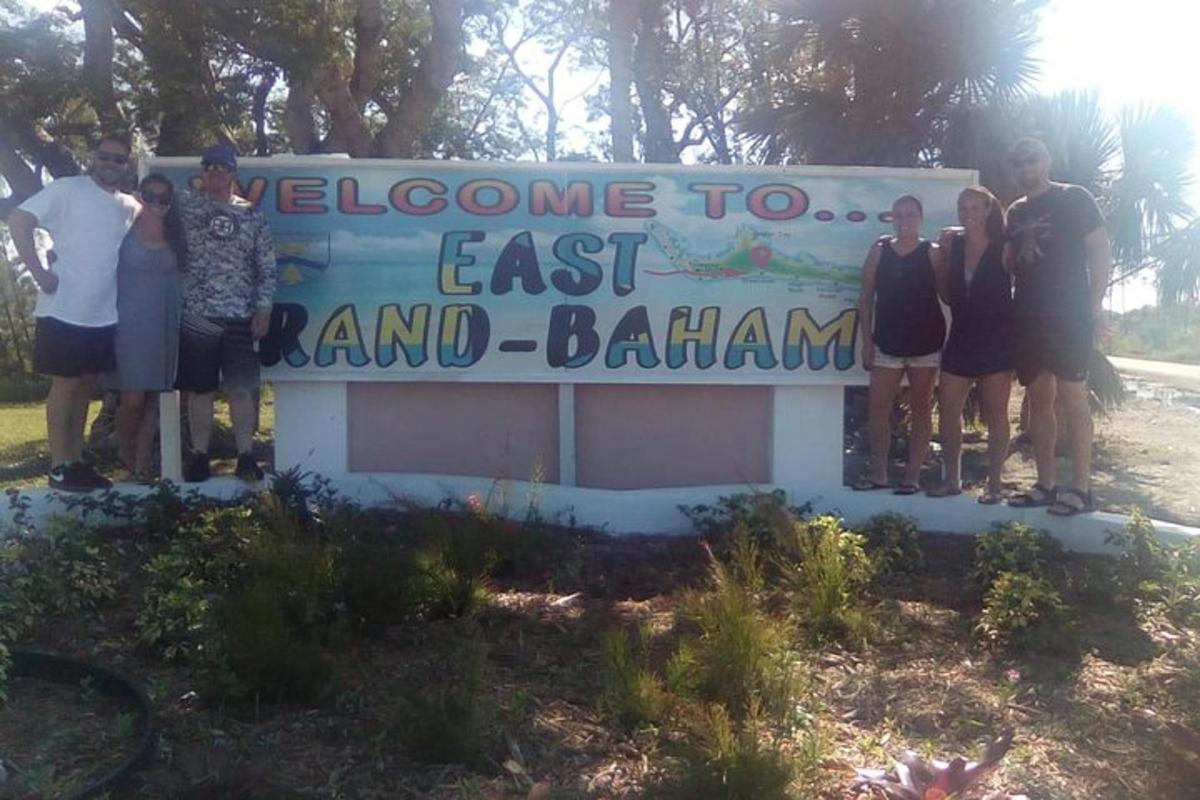 a group of people standing in front of a sign