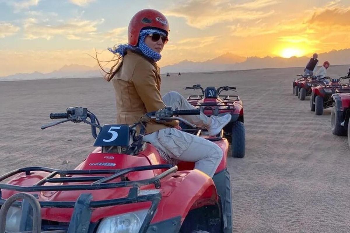 a woman sitting on a four wheeler in the desert