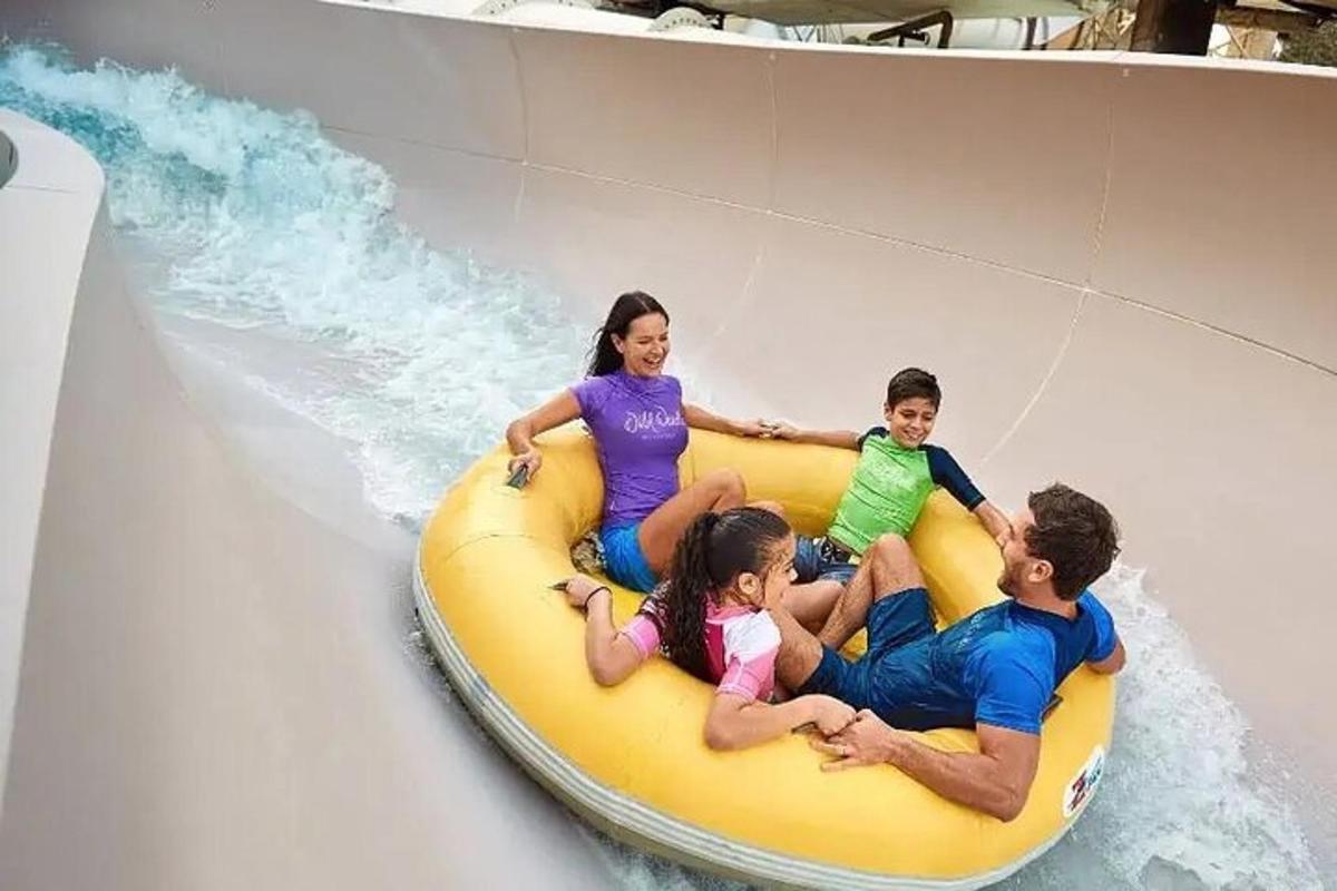 a group of people riding a raft on a water slide