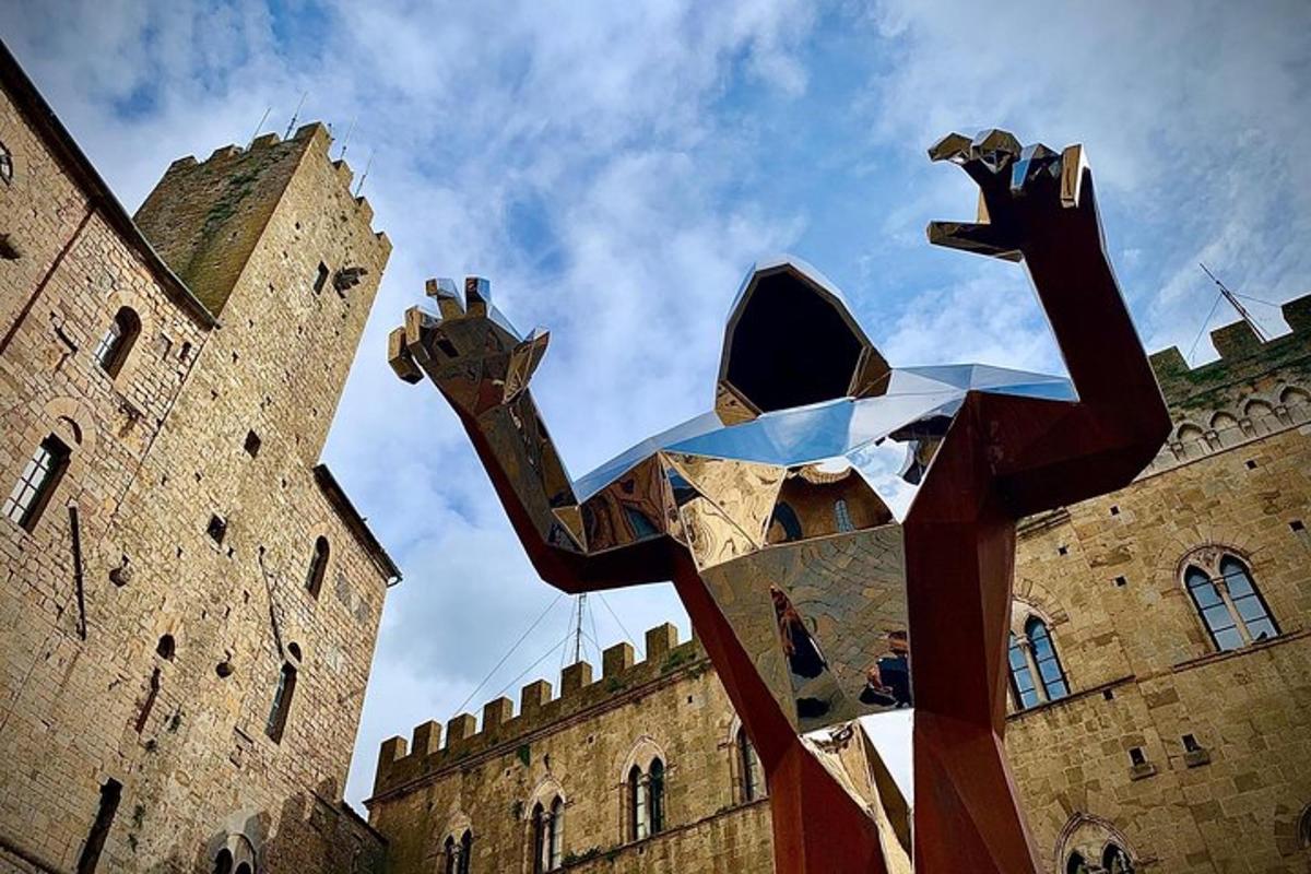 a large metal sculpture in front of a castle