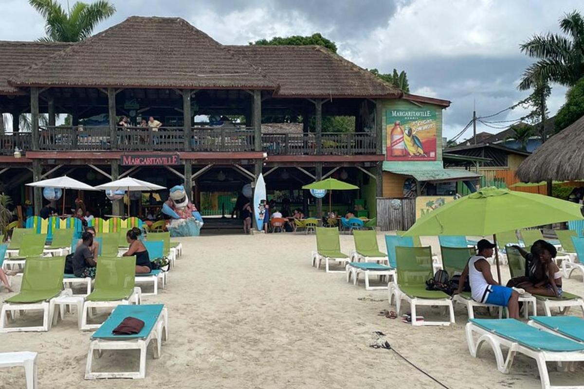 a group of people sitting in chairs on the beach