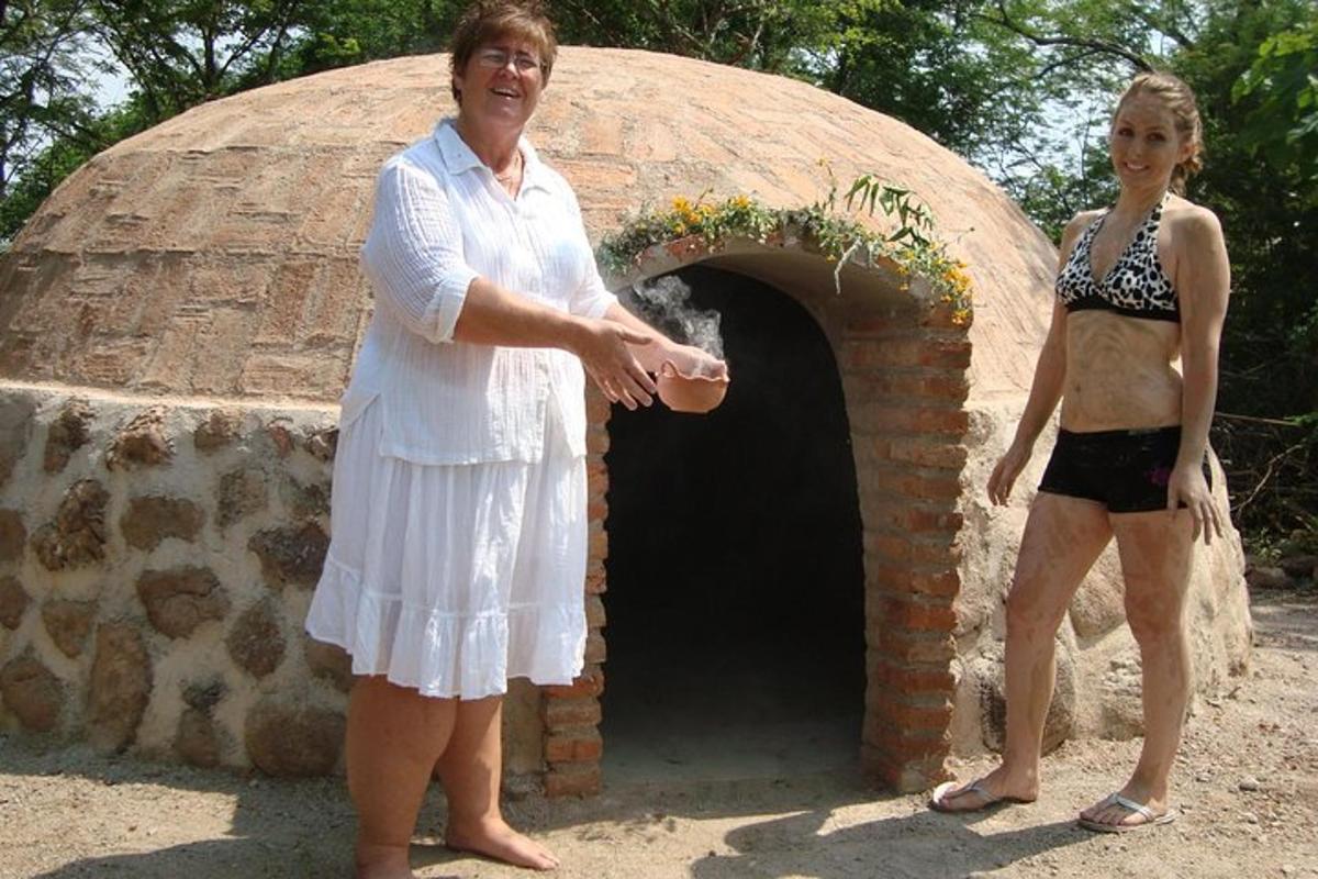 a woman standing in front of a brick oven
