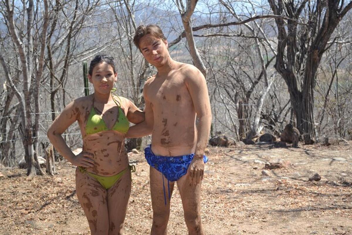 a man and a woman standing in the woods