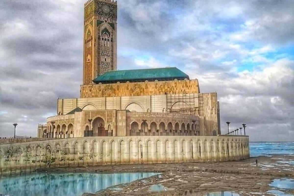 a large building with a clock tower on the water