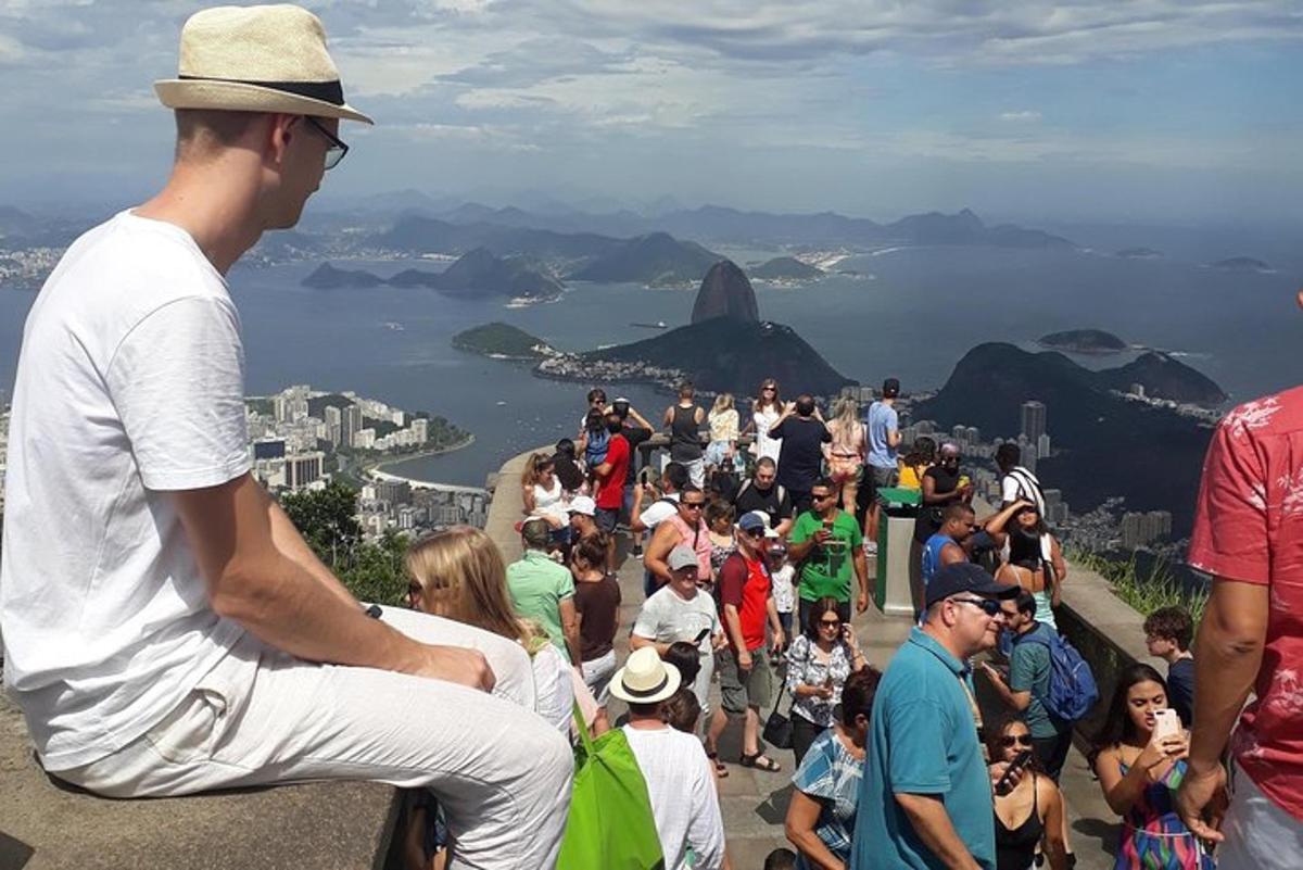 a crowd of people sitting on top of a mountain