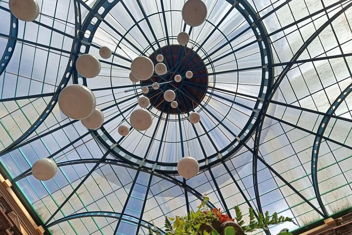 a glass ceiling with a chandelier in a building