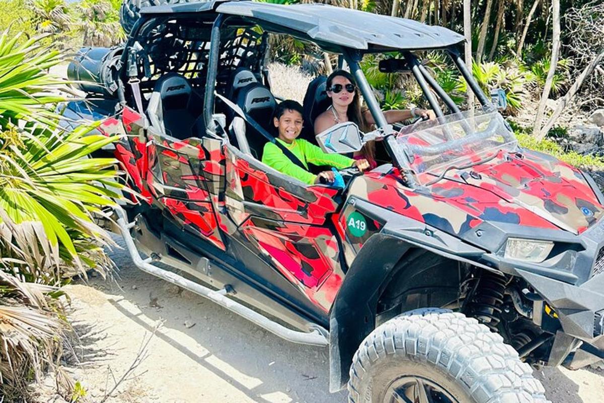 two people are riding in a atv