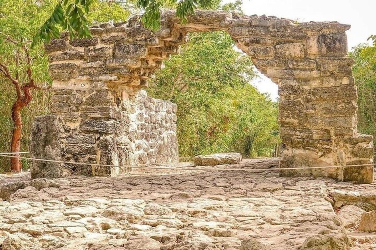 an old stone building with an arch in the middle