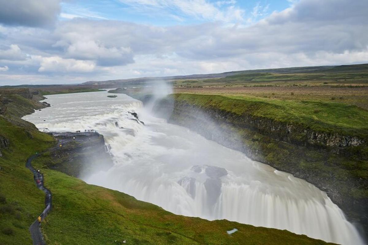 a waterfall on the side of a river