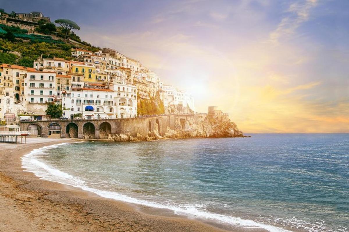a view of a beach with houses on a mountain