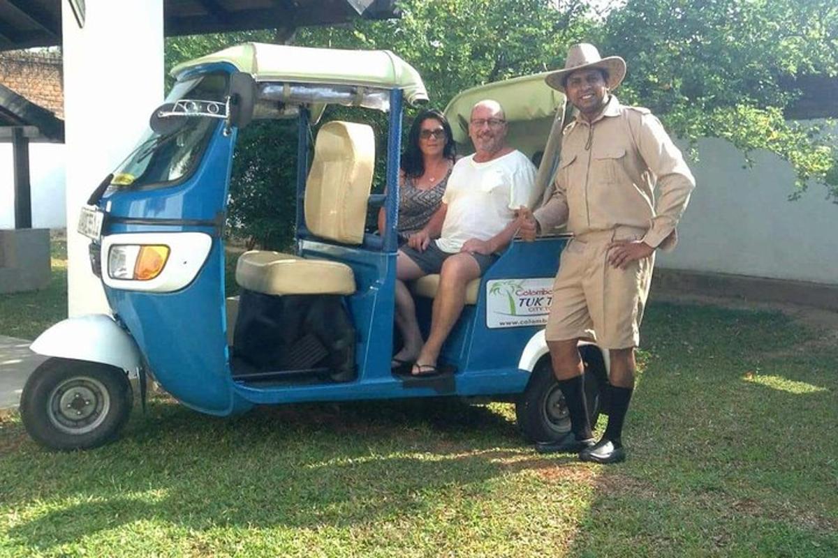 a group of people sitting in the back of a small golf cart