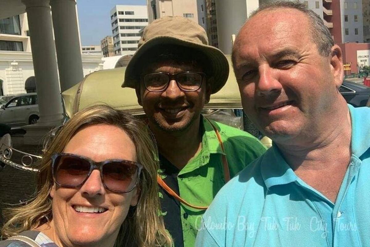 two men and a woman posing for a picture