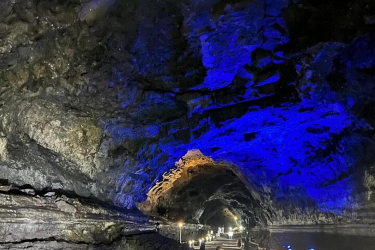a cave with blue lights on the side of it